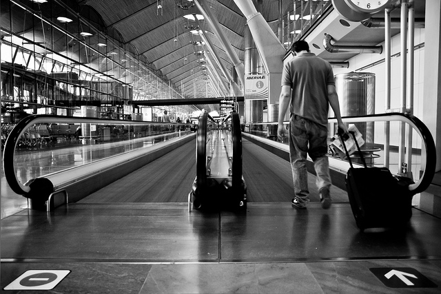 Weary Traveler with Suitcase at Airport